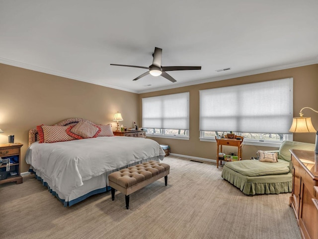 bedroom featuring ornamental molding, light colored carpet, and ceiling fan