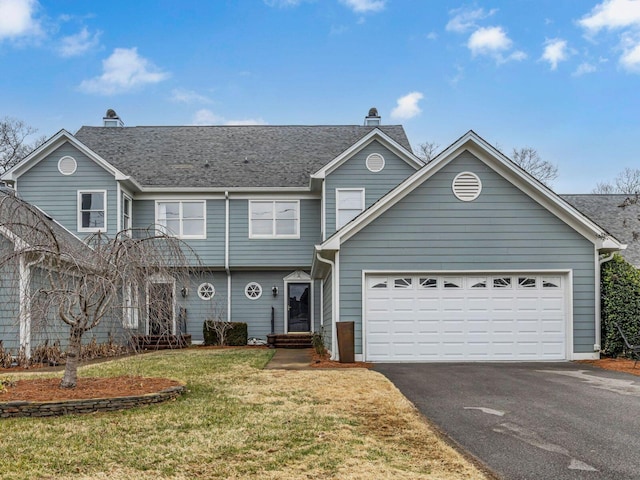 front facade featuring a garage and a front lawn