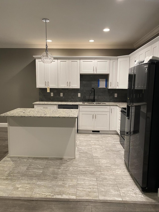 kitchen with pendant lighting, sink, black appliances, and white cabinets