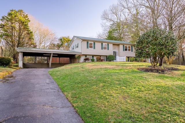 raised ranch featuring a front lawn and a carport