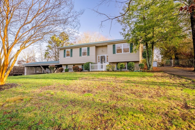 raised ranch featuring a carport and a front yard