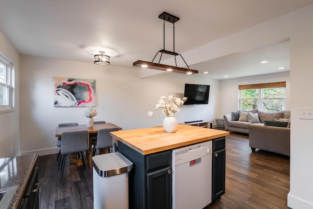 kitchen featuring pendant lighting, wood counters, white dishwasher, and dark hardwood / wood-style floors