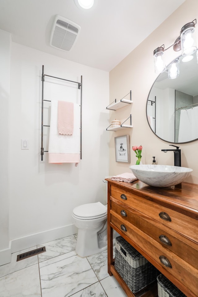 bathroom with vanity and toilet