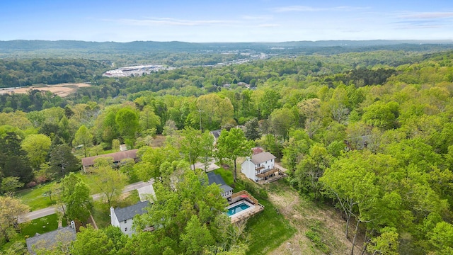 drone / aerial view featuring a forest view