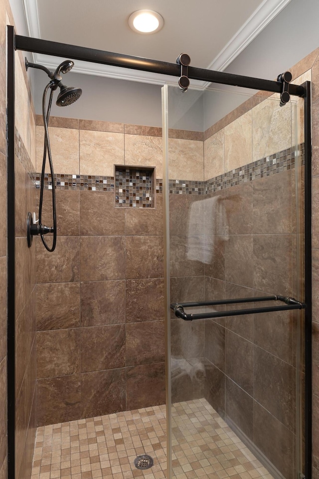 full bath with ornamental molding and a stall shower