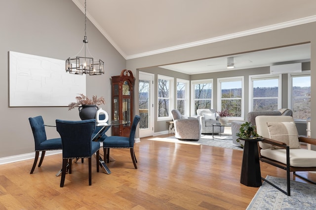 dining area featuring a chandelier, baseboards, light wood-style floors, an AC wall unit, and crown molding