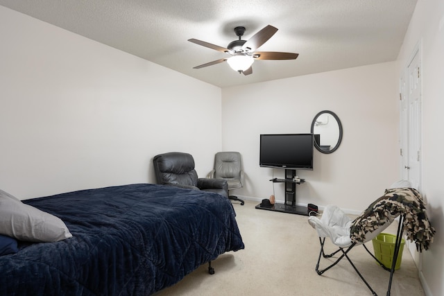 bedroom featuring a textured ceiling, carpet, and ceiling fan