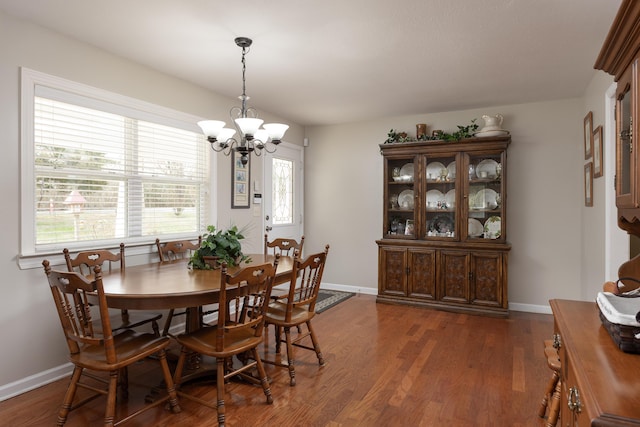 dining room featuring dark wood-type flooring and a chandelier