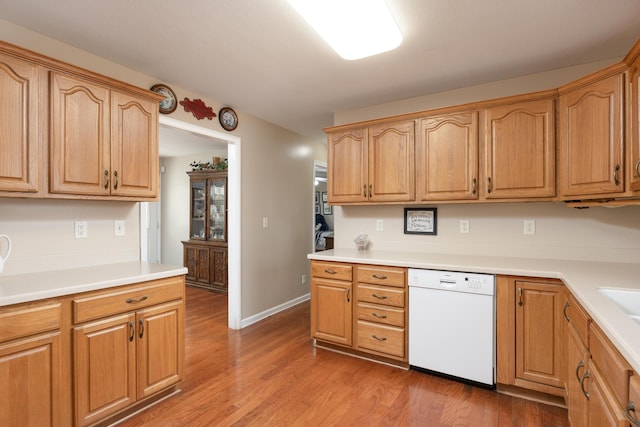 kitchen featuring hardwood / wood-style flooring and white dishwasher