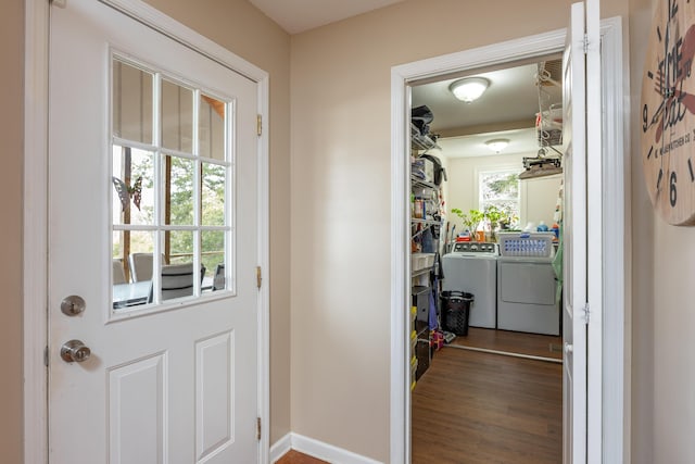 entryway with washer and dryer and dark hardwood / wood-style flooring