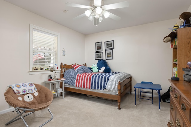 bedroom featuring ceiling fan and light carpet