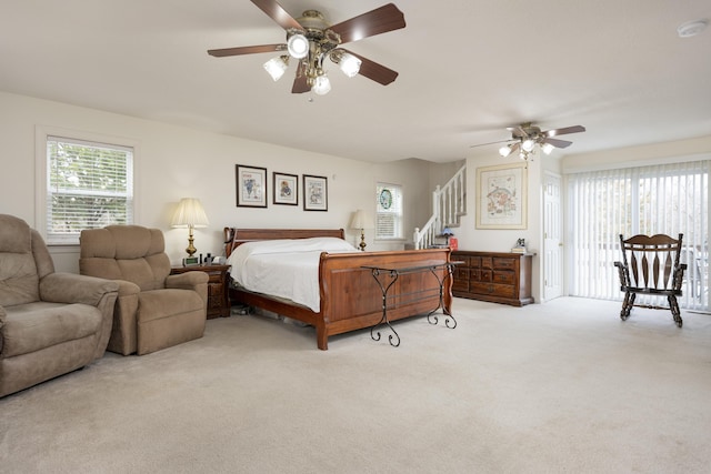 carpeted bedroom featuring ceiling fan and access to outside