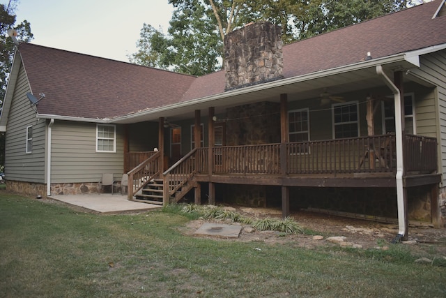 rear view of house featuring a yard, ceiling fan, and a patio area