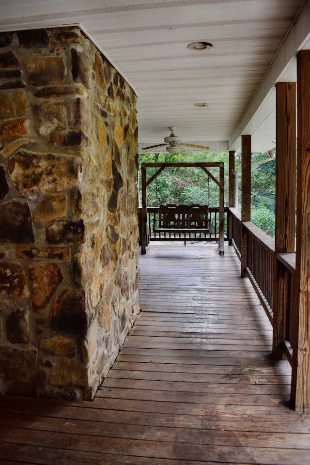 wooden deck with ceiling fan and a porch