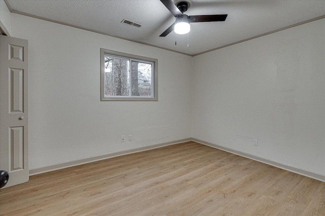 spare room with crown molding, ceiling fan, a textured ceiling, and light wood-type flooring