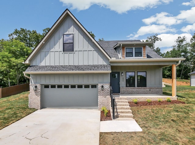 view of front of property with a garage, a porch, and a front lawn