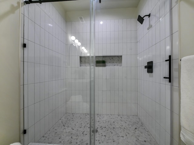 bathroom with a shower with door