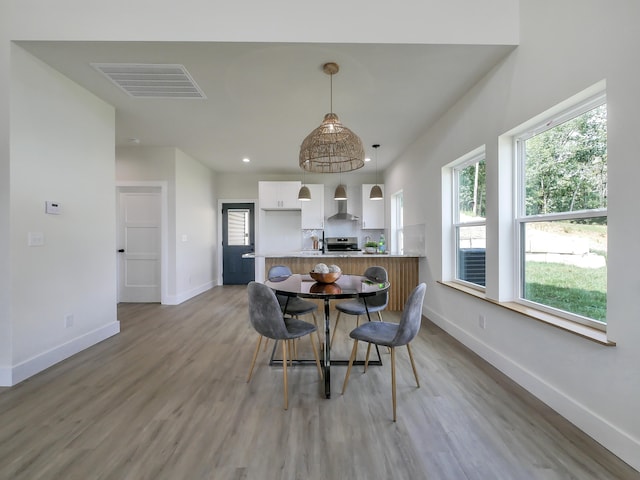 dining space featuring sink and light wood-type flooring