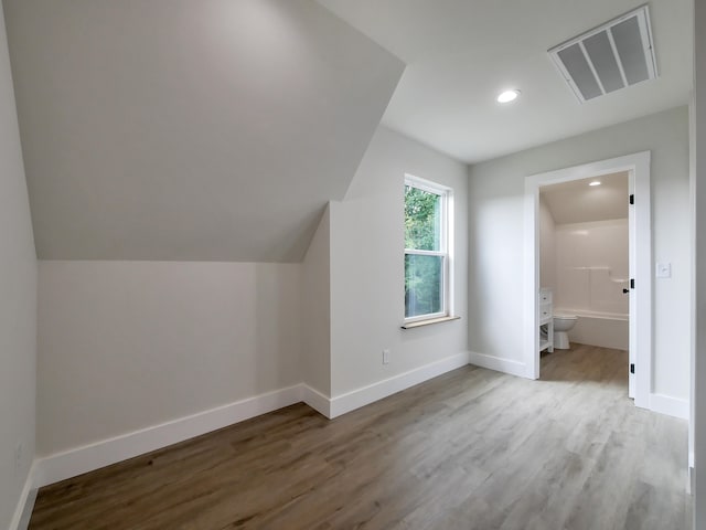 bonus room featuring hardwood / wood-style flooring and vaulted ceiling