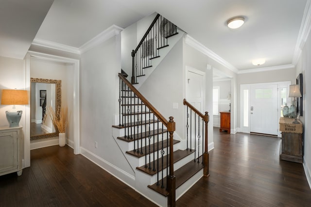 foyer featuring ornamental molding and dark hardwood / wood-style flooring