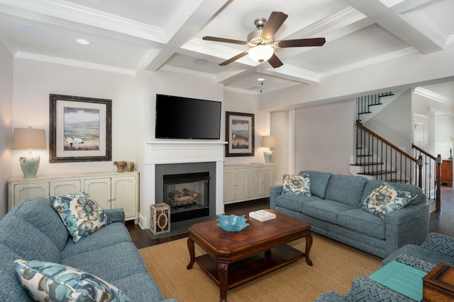 living room with beamed ceiling, coffered ceiling, ceiling fan, crown molding, and light wood-type flooring