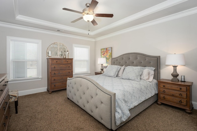 bedroom featuring ornamental molding, a tray ceiling, carpet, and multiple windows