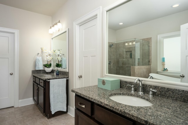 bathroom with vanity, tile patterned floors, and a shower with shower door