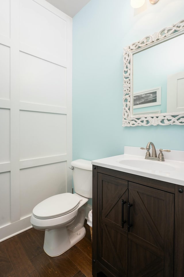 bathroom with vanity, hardwood / wood-style floors, and toilet