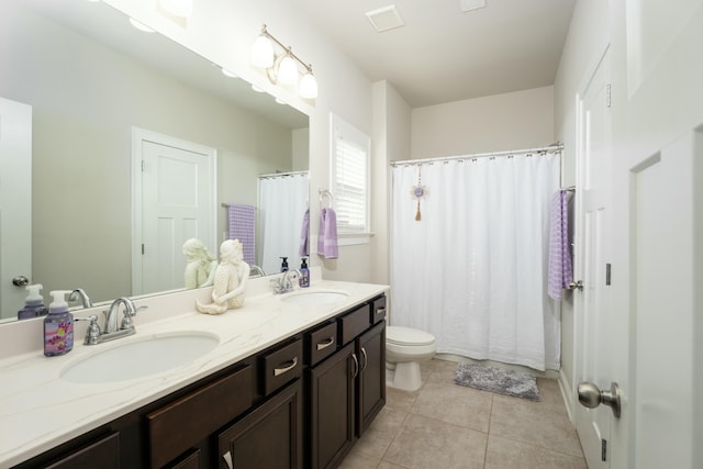 bathroom featuring vanity, tile patterned floors, and toilet