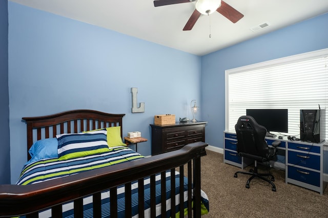 bedroom featuring ceiling fan and dark carpet