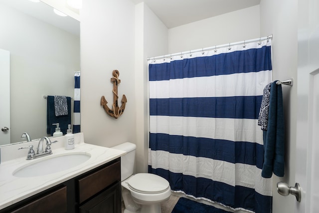 bathroom with vanity, curtained shower, and toilet