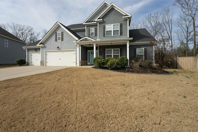 craftsman house with a garage and a front lawn