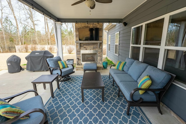 view of patio / terrace with a grill, an outdoor living space with a fireplace, and ceiling fan