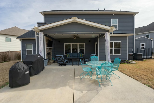 rear view of house featuring a yard, a patio area, outdoor lounge area, and ceiling fan