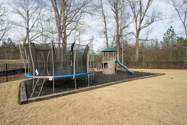 view of play area with a trampoline and a yard