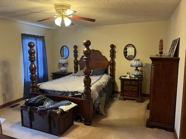 carpeted bedroom featuring ceiling fan and a textured ceiling