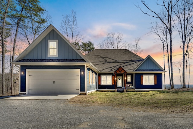 view of front of home with board and batten siding, roof with shingles, driveway, and a garage