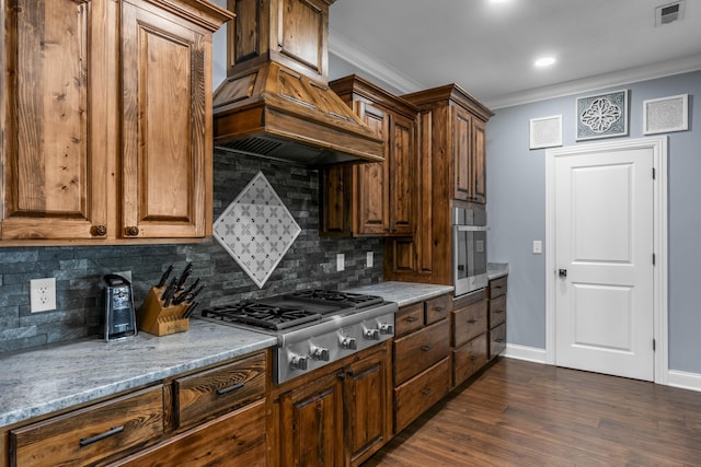 kitchen with visible vents, appliances with stainless steel finishes, dark wood-style flooring, custom exhaust hood, and crown molding