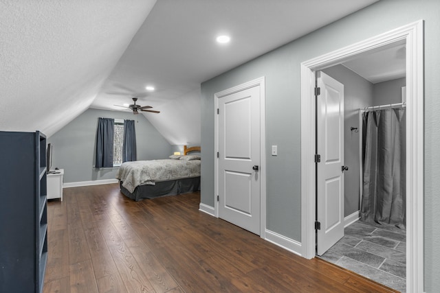 bedroom featuring ceiling fan, baseboards, vaulted ceiling, and dark wood-style flooring