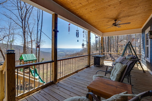 wooden deck featuring ceiling fan