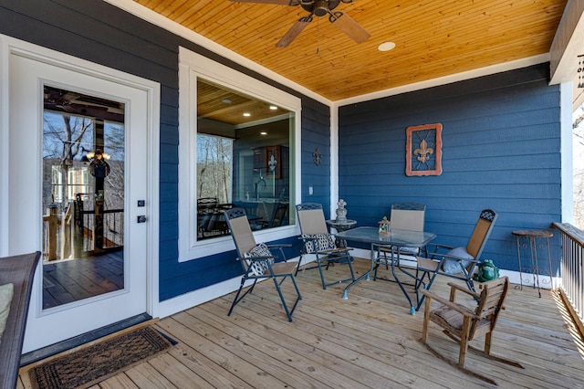 wooden terrace featuring ceiling fan