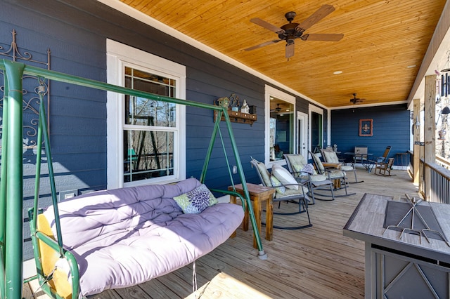 deck with a ceiling fan and covered porch