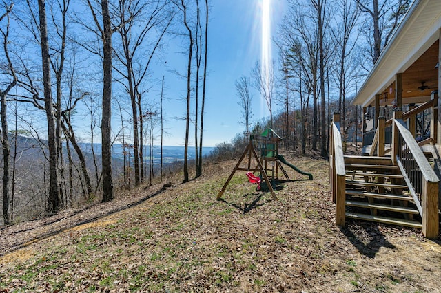 view of playground featuring a ceiling fan and stairs