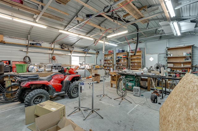 garage featuring a workshop area and metal wall