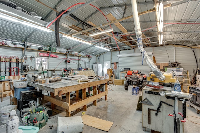 garage with a workshop area and metal wall