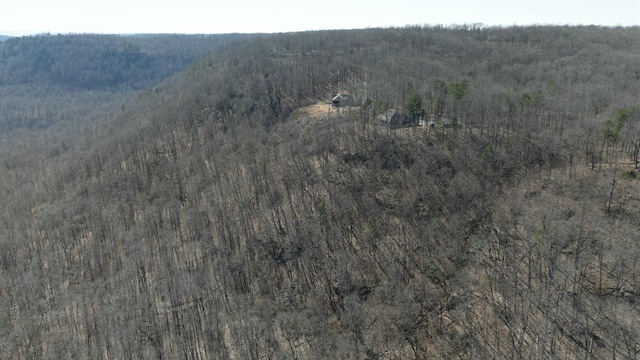 birds eye view of property featuring a view of trees