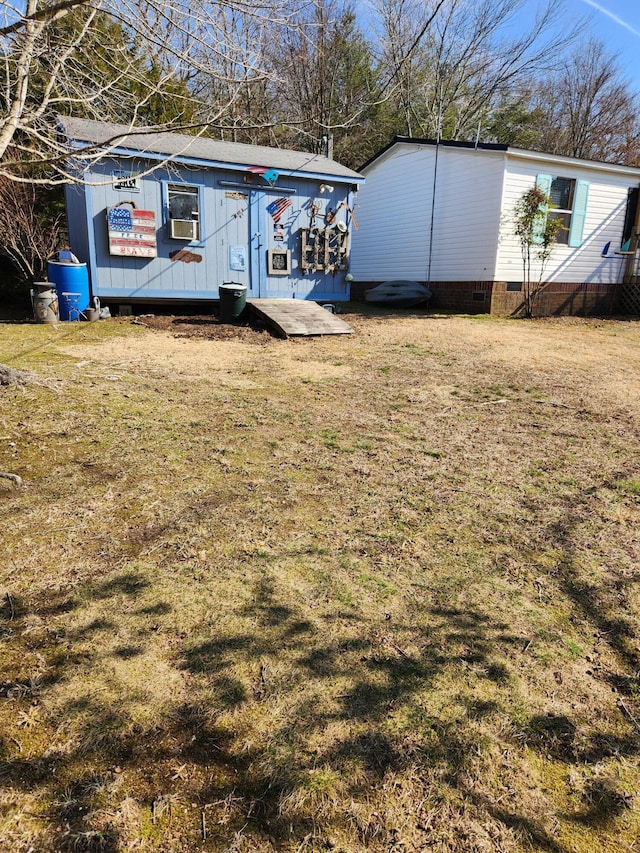 exterior space featuring cooling unit and a front lawn