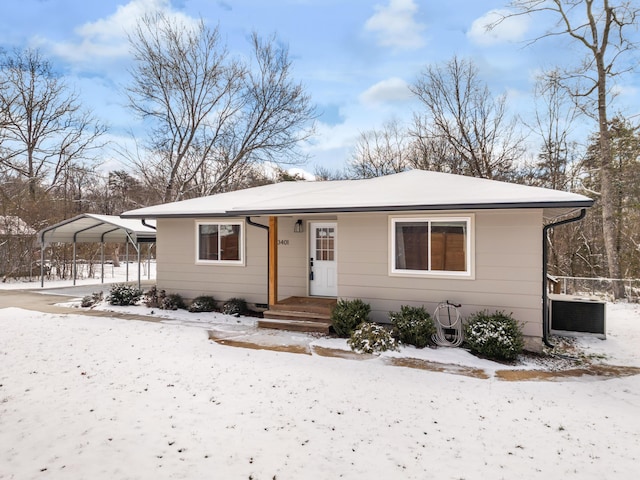 bungalow-style home featuring cooling unit and a detached carport