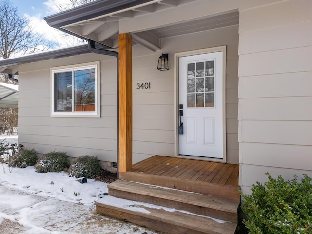 view of snow covered property entrance