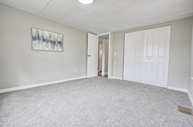 unfurnished bedroom featuring a closet and carpet flooring